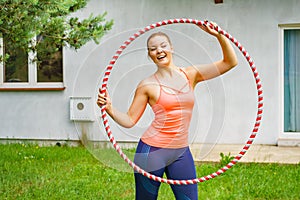 Young woman with hoola hoop outdoors