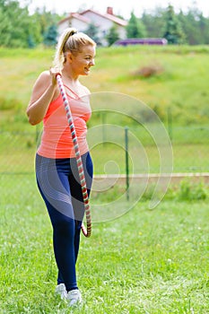 Young woman with hoola hoop outdoors