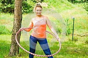 Young woman with hoola hoop outdoors