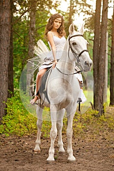 Young woman on a horse. Horseback rider, woman riding horse