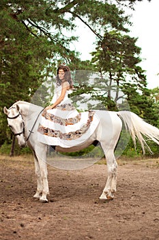 Young woman on a horse. Horseback rider, woman riding horse