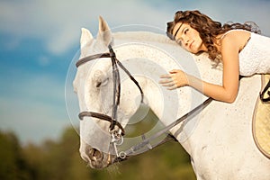 Young woman on a horse. Horseback rider, woman riding horse on b