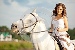 Young woman on a horse. Horseback rider, woman riding horse on b