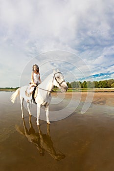 Young woman on a horse. Horseback rider, woman riding horse on b