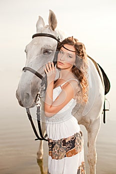 Young woman on a horse. Horseback rider, woman riding horse on b