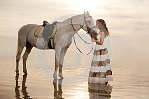 Young woman on a horse. Horseback rider, woman riding horse on b