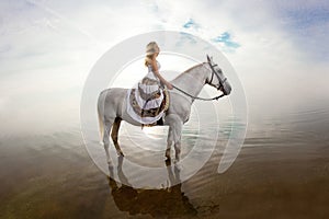 Young woman on a horse. Horseback rider, woman riding horse on b