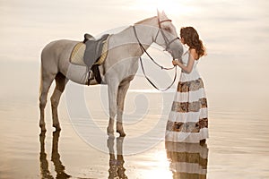 Young woman on a horse. Horseback rider, woman riding horse on b