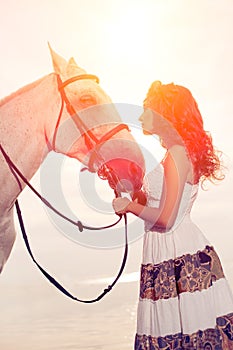 Young woman on a horse. Horseback rider, woman riding horse on b