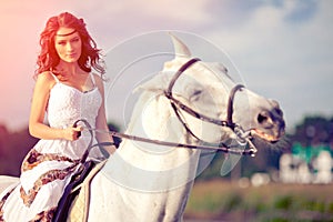 Young woman on a horse. Horseback rider, woman riding horse on b