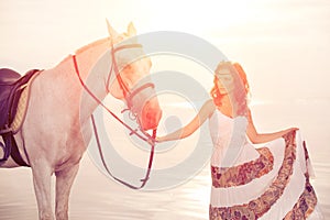 Young woman on a horse. Horseback rider, woman riding horse on b