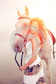 Young woman on a horse. Horseback rider, woman riding horse on b