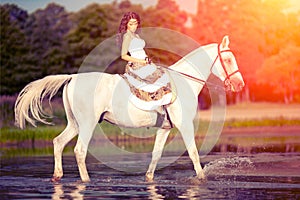 Young woman on a horse. Horseback rider, woman riding horse on b