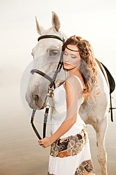 Young woman on a horse. Horseback rider, woman riding horse on b