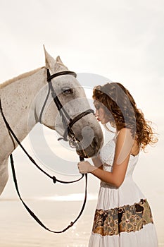 Young woman on a horse. Horseback rider, woman riding horse on b