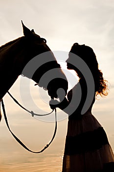 Young woman on a horse. Horseback rider, woman riding horse on b photo
