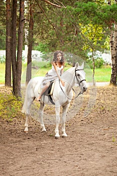 Young woman on a horse. Horseback rider, woman riding horse