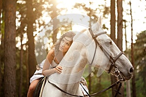 Young woman on a horse. Horseback rider, woman riding horse photo