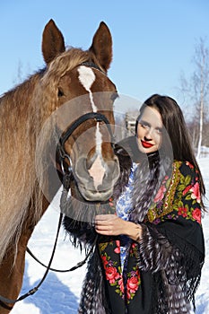 Young woman with horse in winter