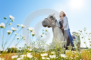 Young woman horseriding beautiful white horse