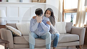 Young woman hug comfort upset husband at home