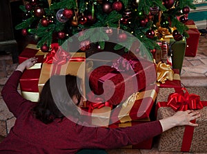 Young woman hugging boxes with new year gift