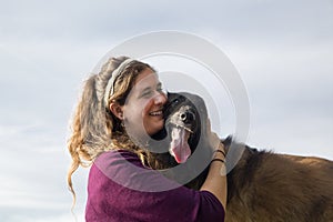 Young Woman Hugging her Dog