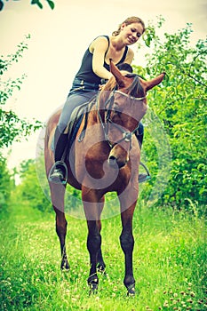 Young woman hugging and leaning out of house