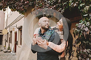 Young woman hugs her boyfriend in the city