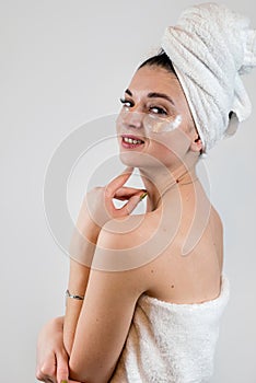 young woman with hydrogel eye patches isolated on white