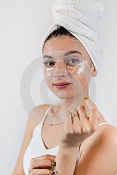 young woman with hydrogel eye patches isolated on white
