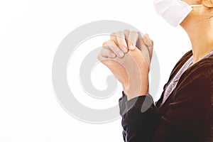 Young woman in hygienic mask are praying.