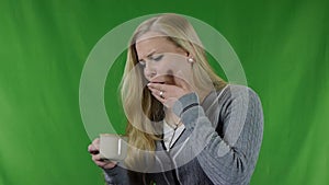 Young woman with hypersensitive teeth drinking a cup of hot drink, sensitive teeth