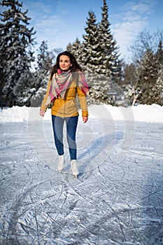 Young woman ice skating outdoors on a pond