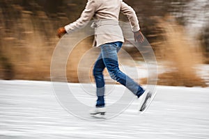 Young woman ice skating outdoors on a pond