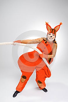 Young woman in image of red squirrel pulling a rope