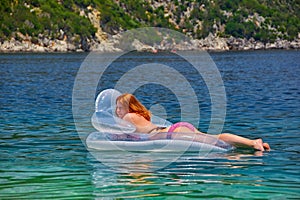 Young Woman in inflatable Matress in the Sea photo