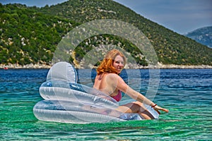 Young Woman in inflatable Matress in the Sea photo