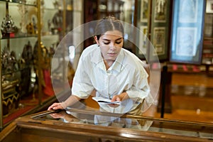 Young woman with information booklet visiting museum