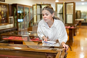 Young woman with information booklet visiting museum