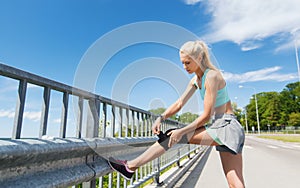 Young woman with injured knee or leg outdoors