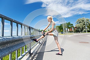 Young woman with injured knee or leg outdoors