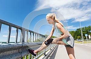 Young woman with injured knee or leg outdoors