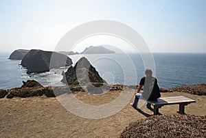 Young woman at Inspiration Point on East Anacapa Island in Channel Islands National Park, California.