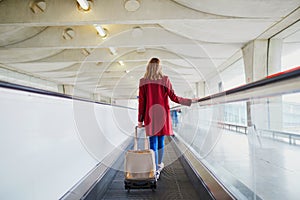 Young woman in international airport with luggage