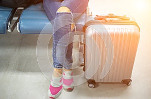 Young woman at international airport, waiting for her flight