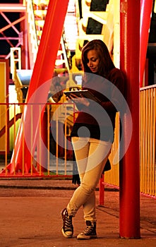 Young woman with iPad at theme park