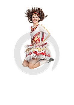 Young woman in irish dance dress jumping