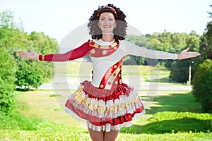 Young woman in irish dance dress welcoming outdoor