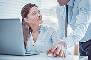 Young woman irritably asking her unprofessional coworker